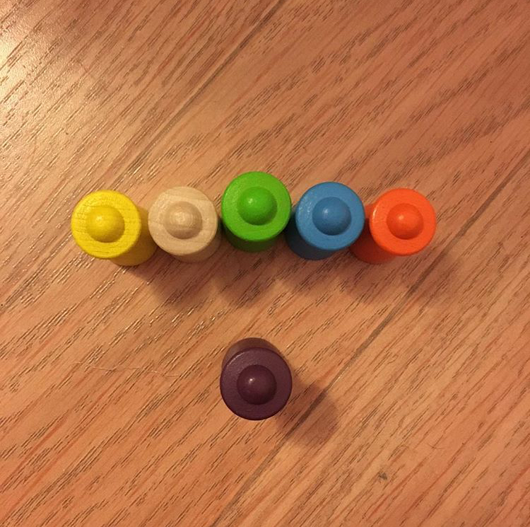 Firing squad or poetry reading? image of six markers from a board game arranged so that one faces a row of five