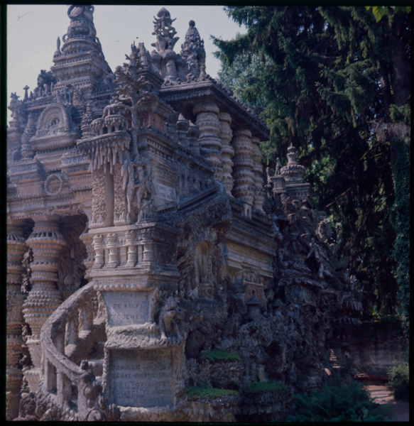 A dark castle with a spiral staircase and trees in the background
