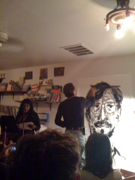 Bhargavi Mandava reading accompanying/accompanied by Mark Sylbert drawing in the front room.