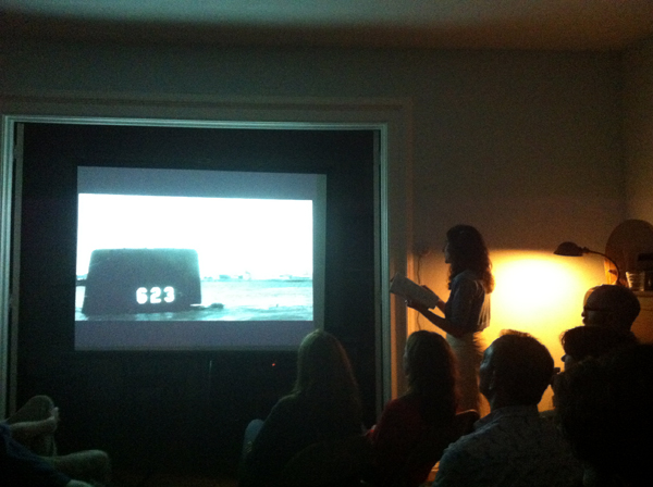 Jen Hofer performing a live film narration piece with an image from the film “On The Beach” at an Evening of Various Wonders (inspired by those on Elm Street) at the home of Anna Moschovakis and Trevor Wilson in South Kortright, NY.